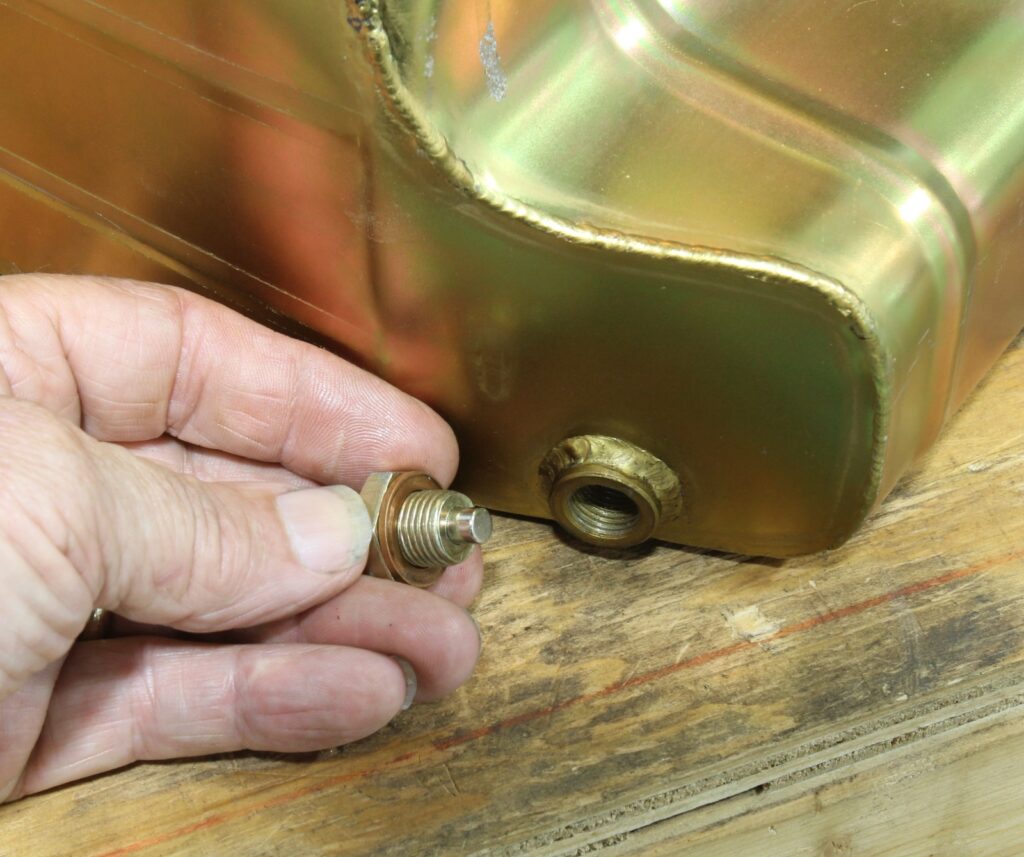 Oil pan drain plug with copper washer