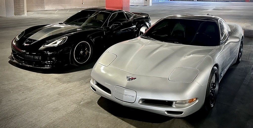 a C6 & C5 Corvette in a parking garage