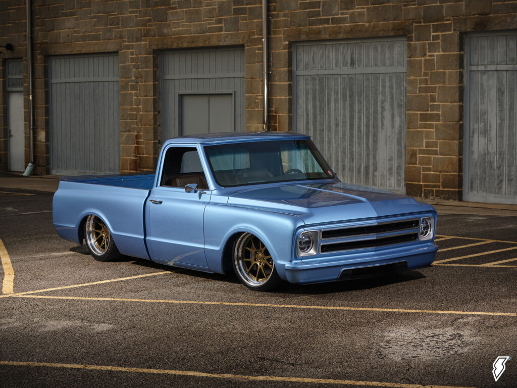 custom chevy c10 truck in front of a warehouse